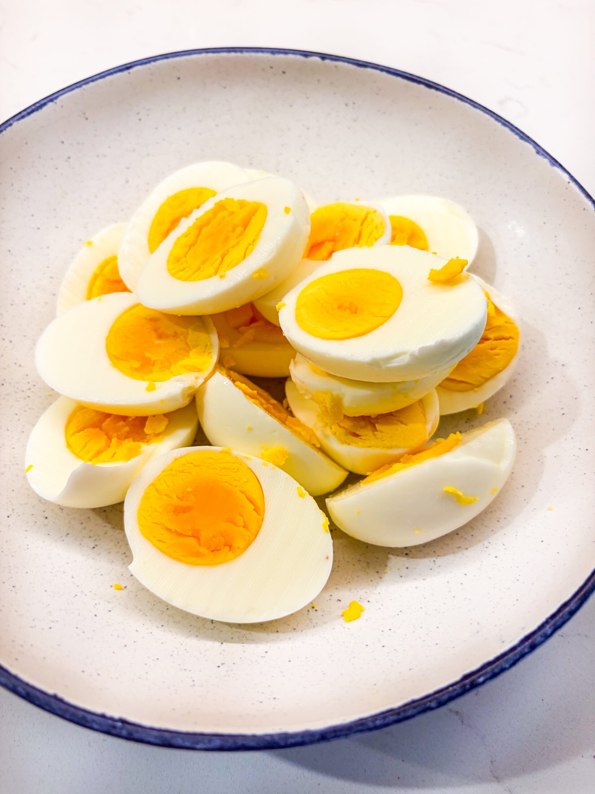 Sliced hard boiled eggs in a bowl