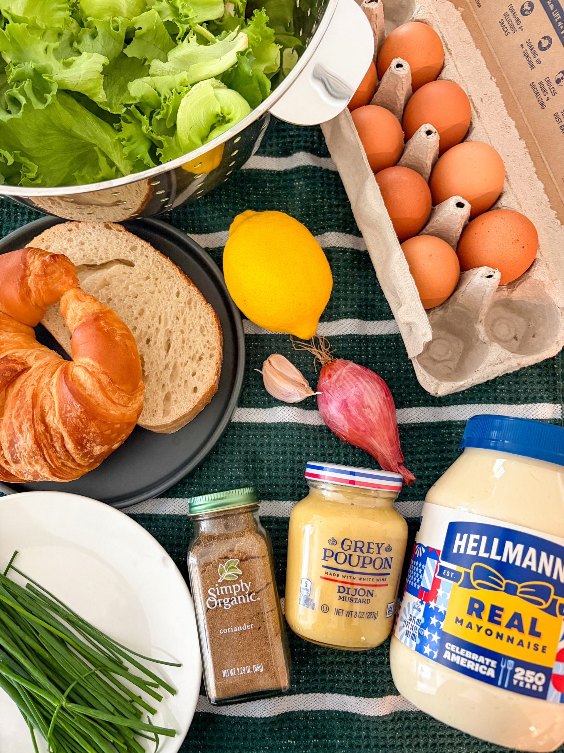 Egg salad recipe ingredients laid out on a dish towel