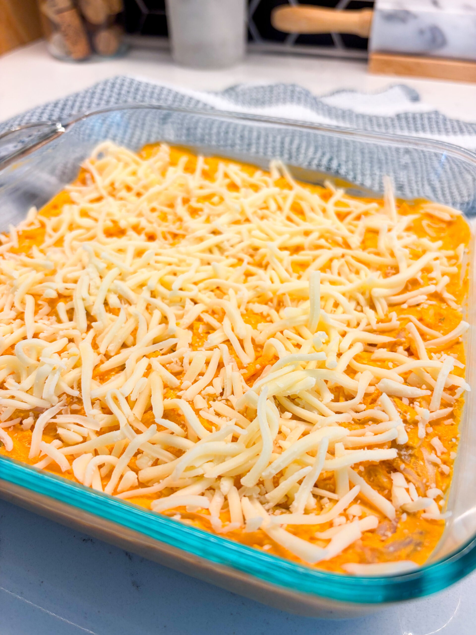 Assembled buffalo chicken dip in glass pan