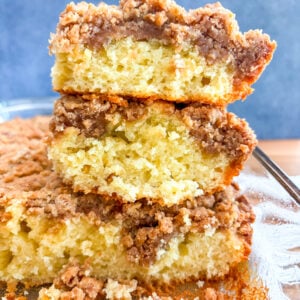 Coffee cake slices stacked on each in glass pan
