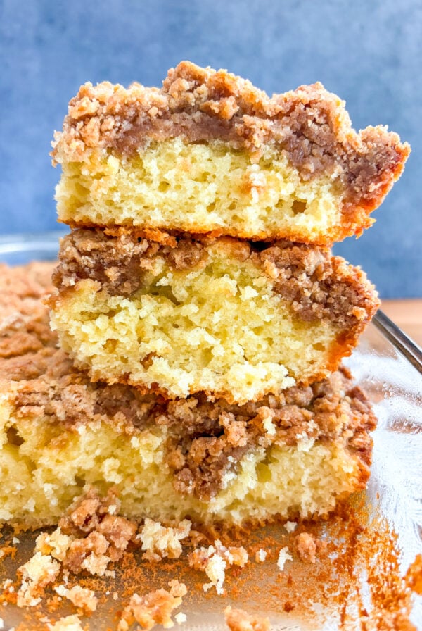 Coffee cake slices stacked on each in glass pan