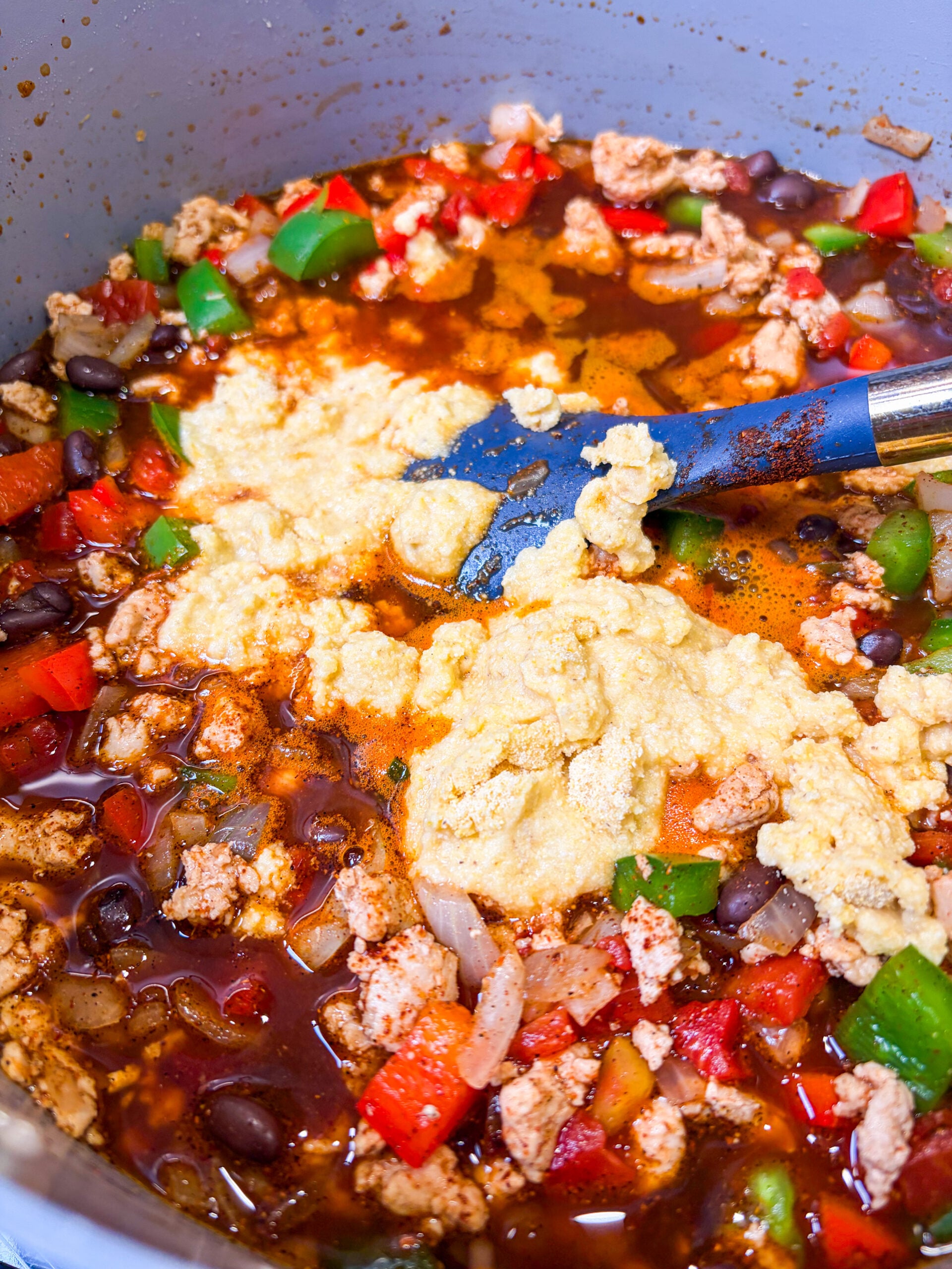 Pot of chicken chili with masa flour slurry added in