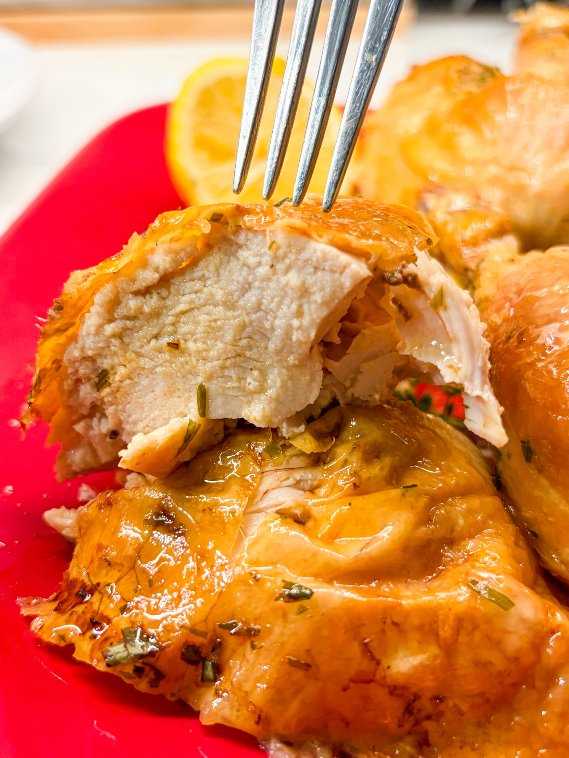 Juicy chicken breast cut open with fork