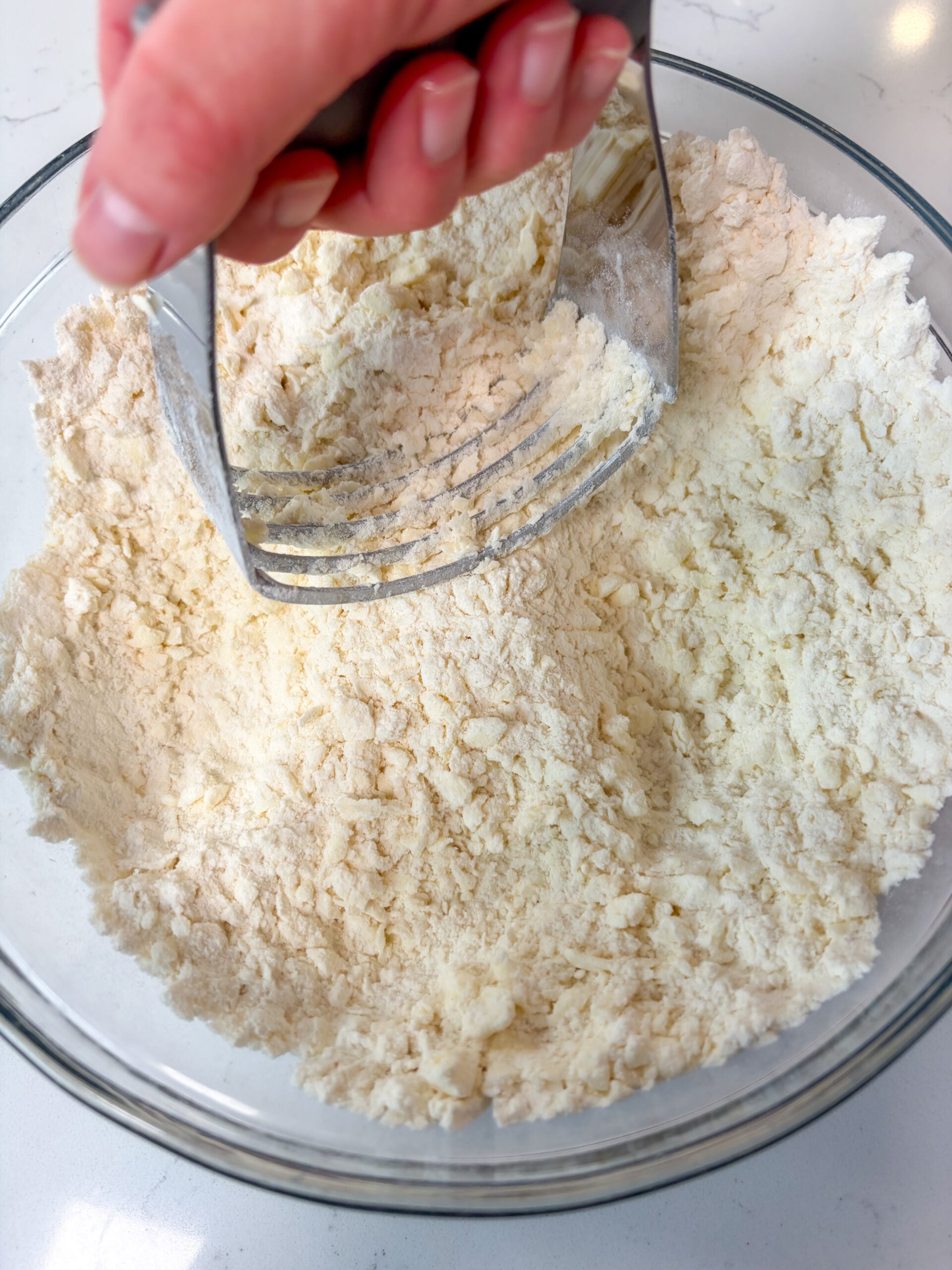 Butter being cut into flour mixture