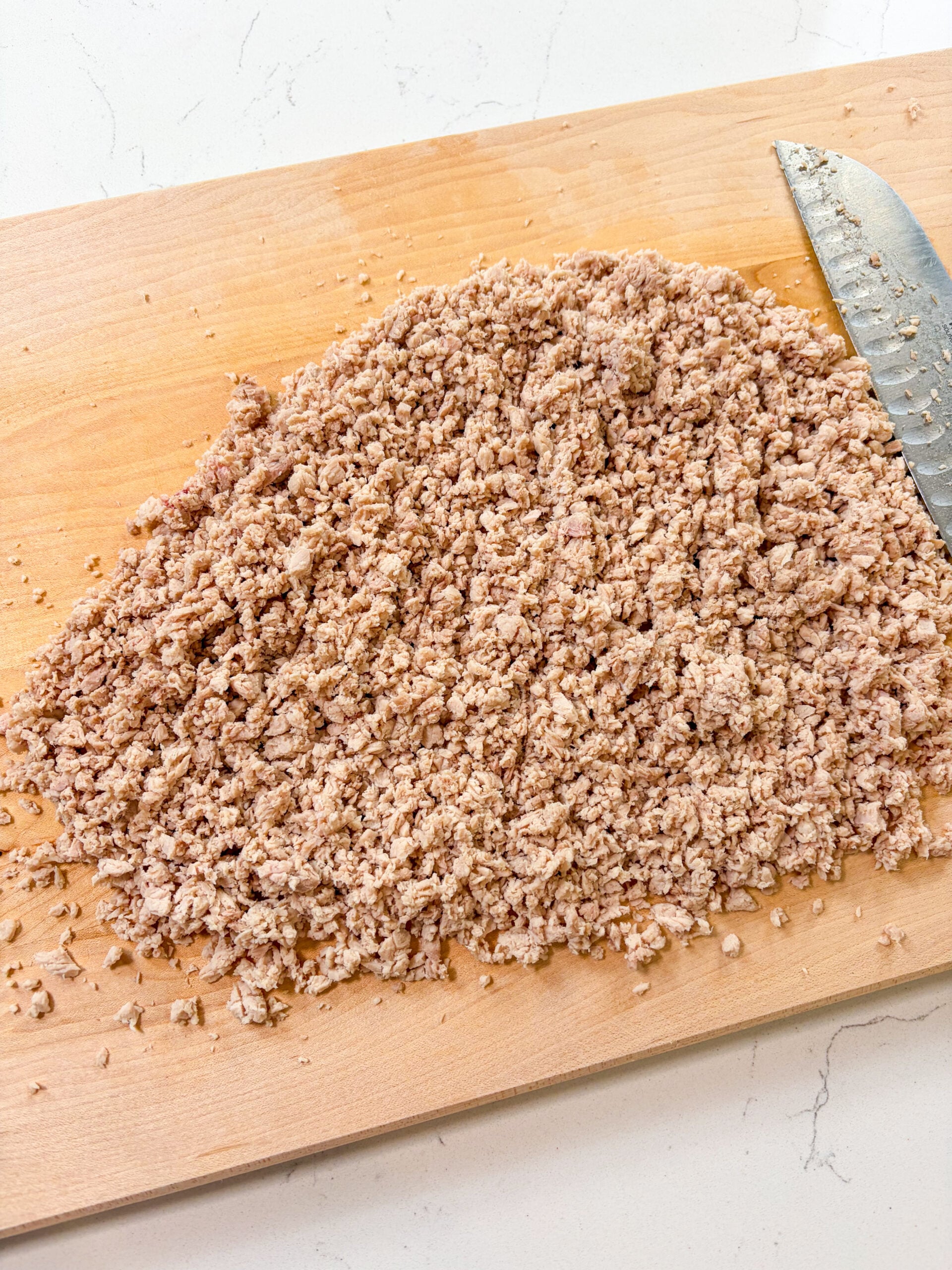 Pork finely minced on a cutting board