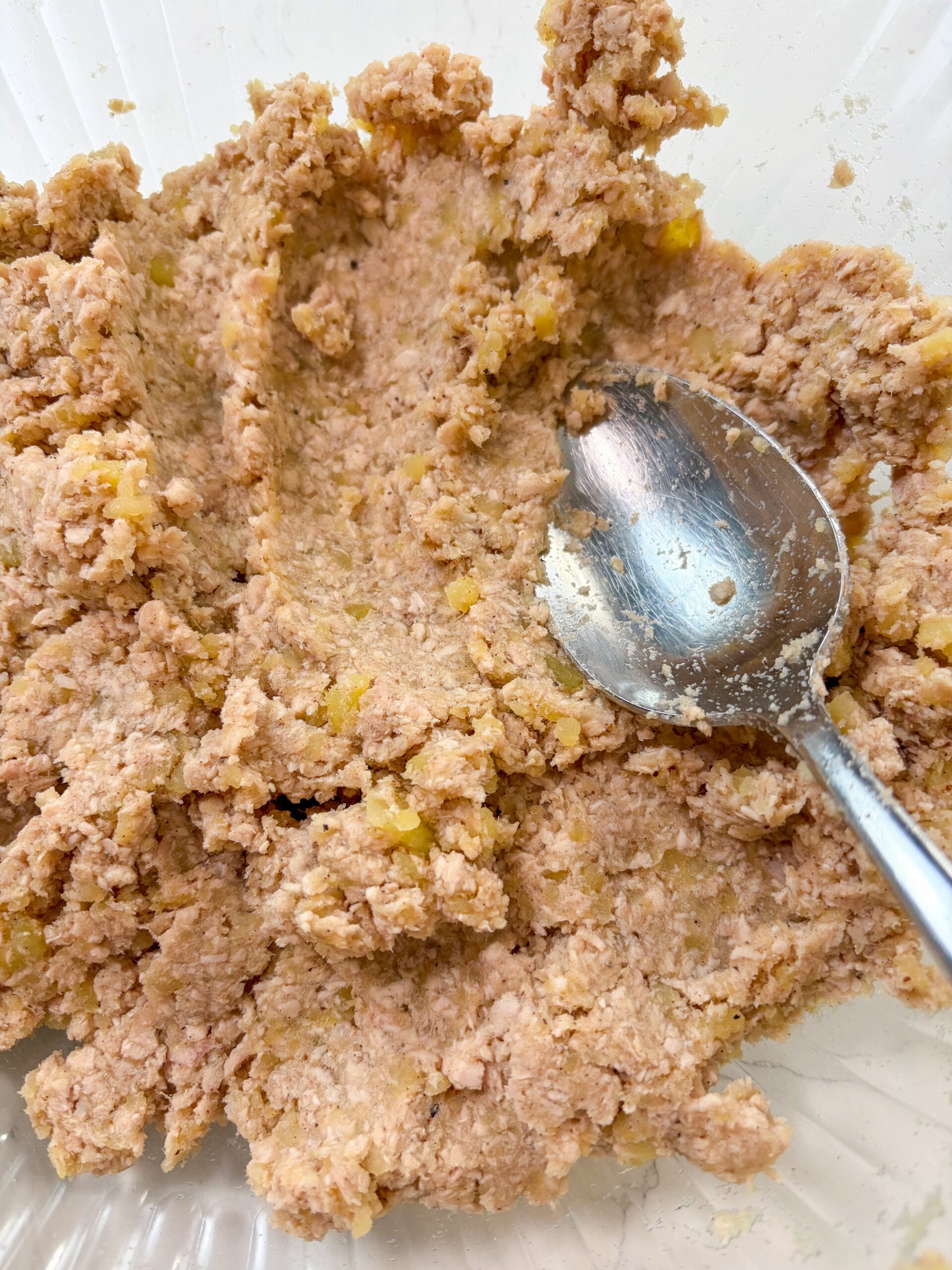 Pork and potato mixture blended together with large spoon